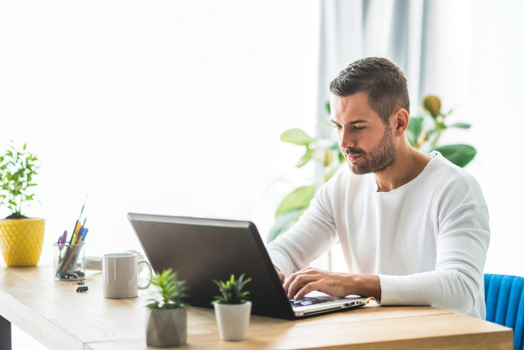 Professional working on a laptop in an office workspace