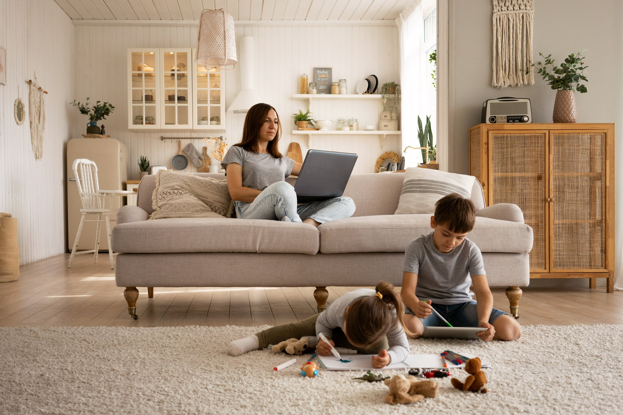 Mom and two sons in living room with computers
