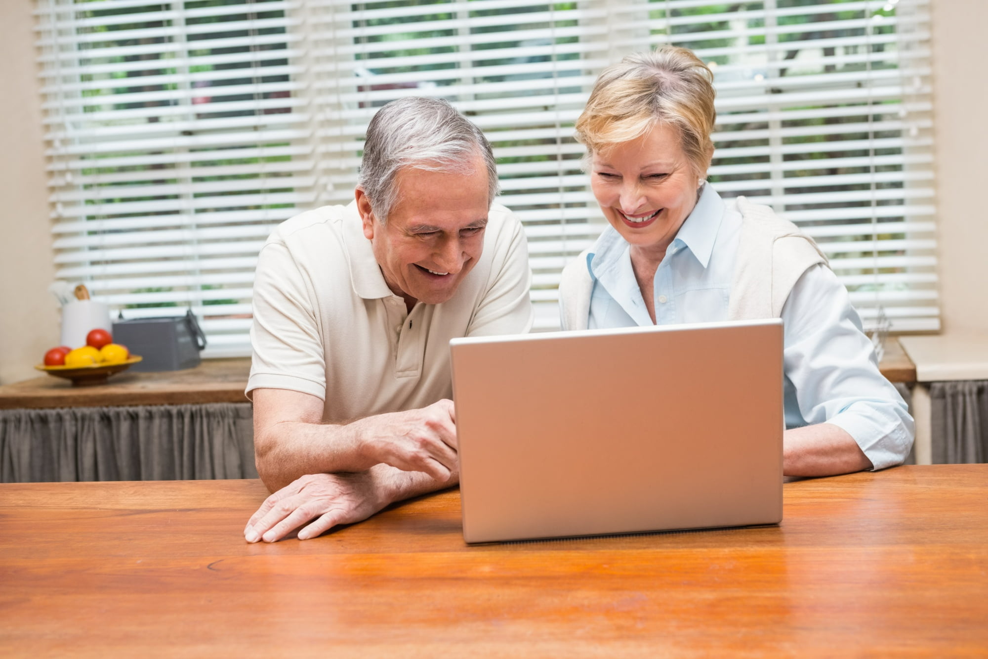 Senior couple working on laptop 